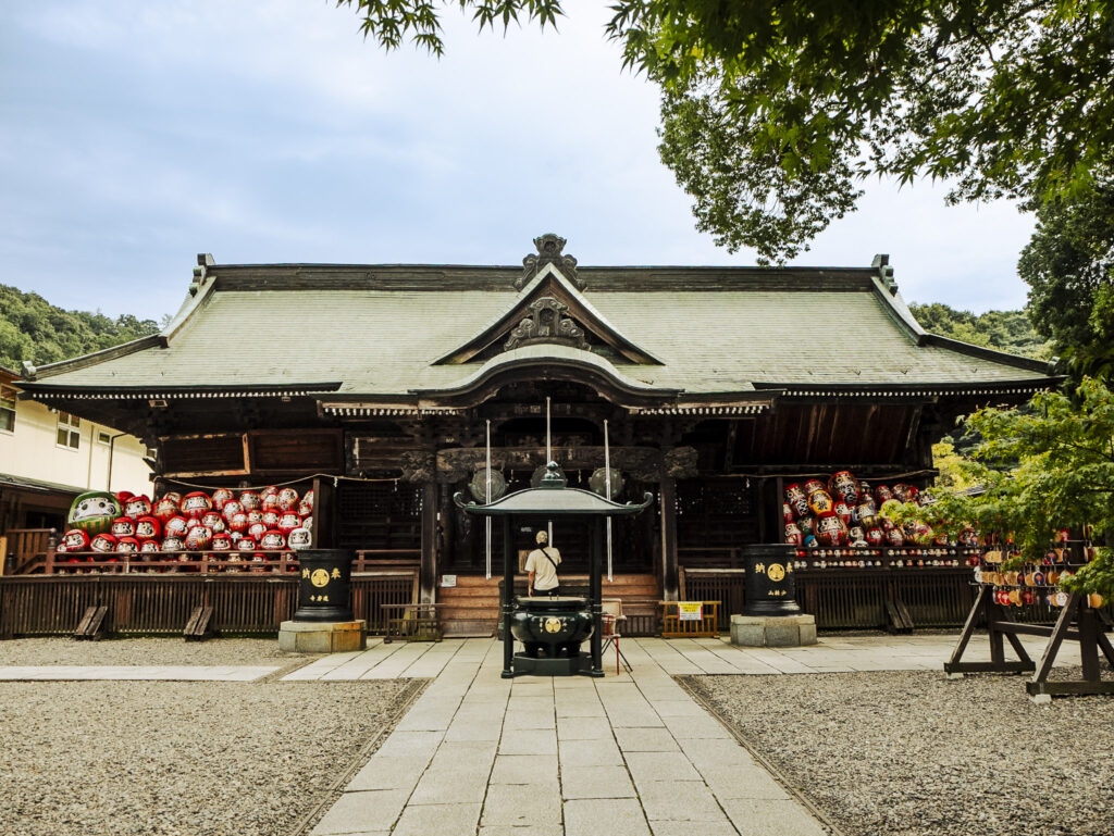 Journey to Gunma Prefecture to discover the legendary temple behind one of Japan's most recognizable symbols of perseverance and good fortune.